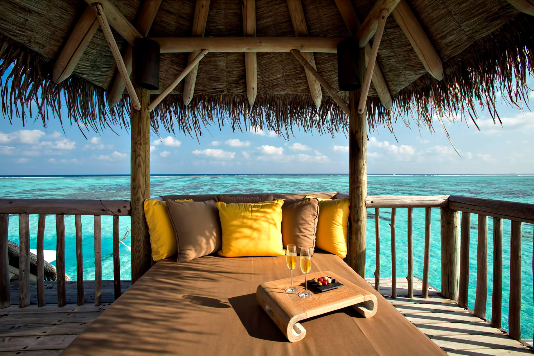 Overwater villa deck lounge with ocean view