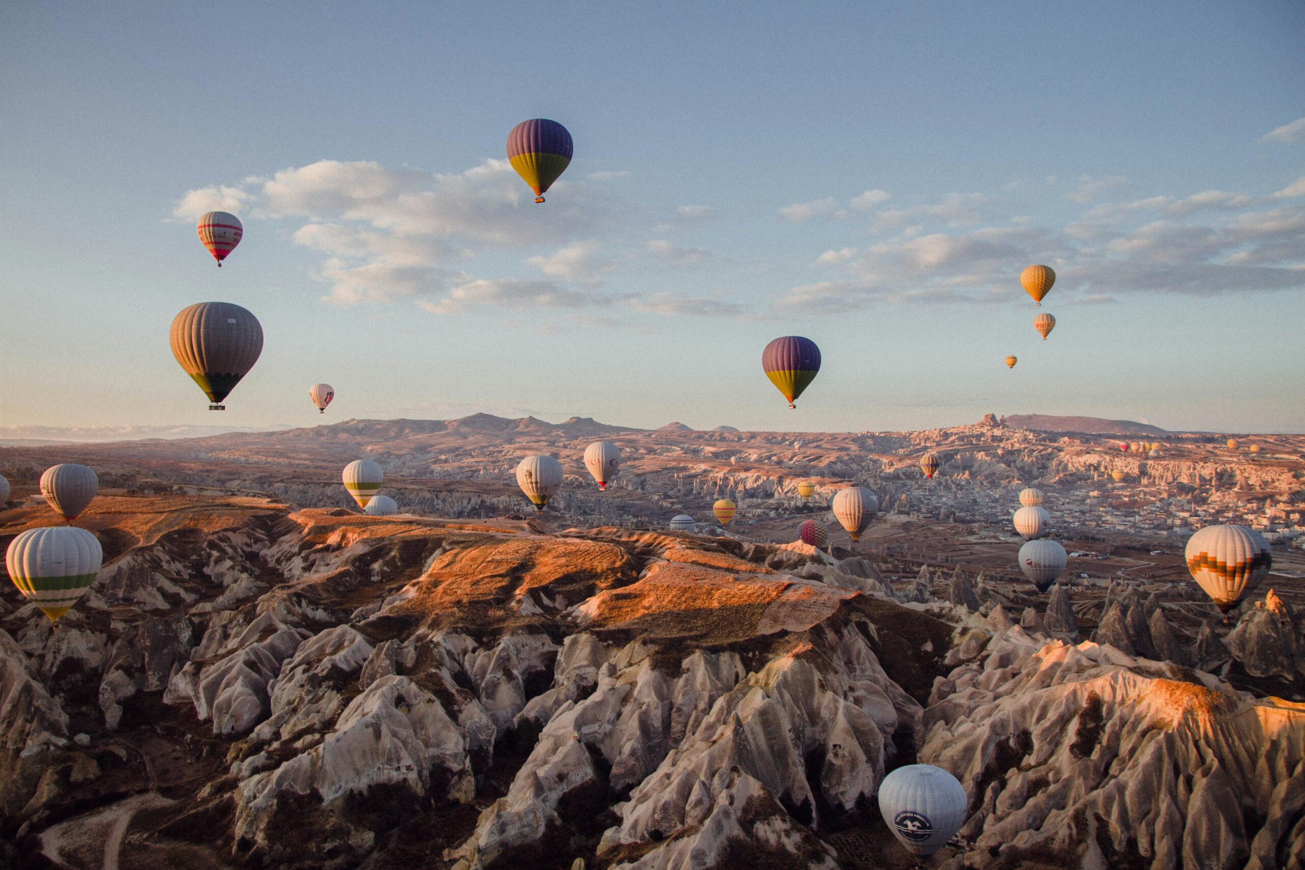 Hot air balloons over the fairy chimneys of Cappadocia at sunrise