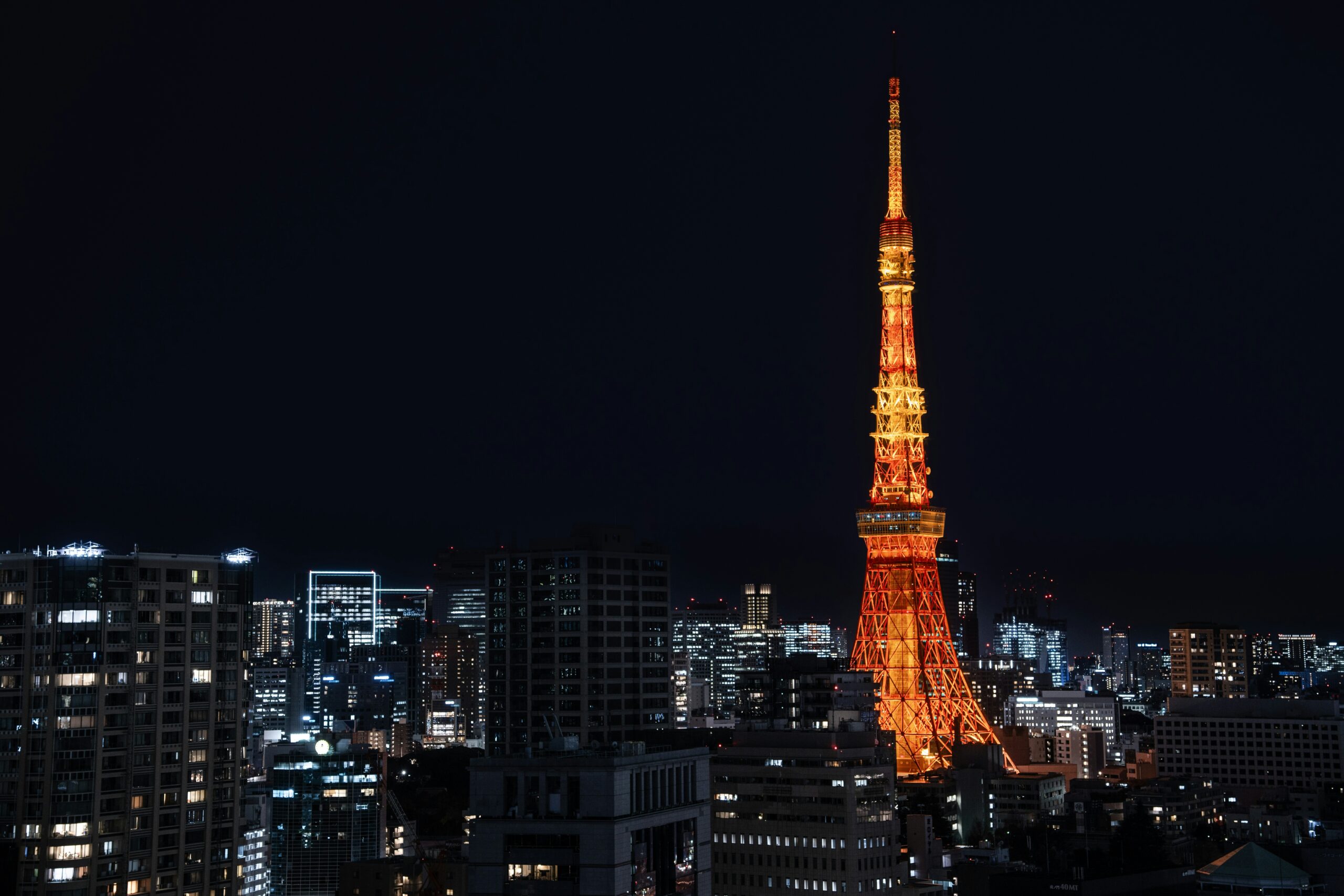 Tokyo Tower illuminated at night against the city skyline