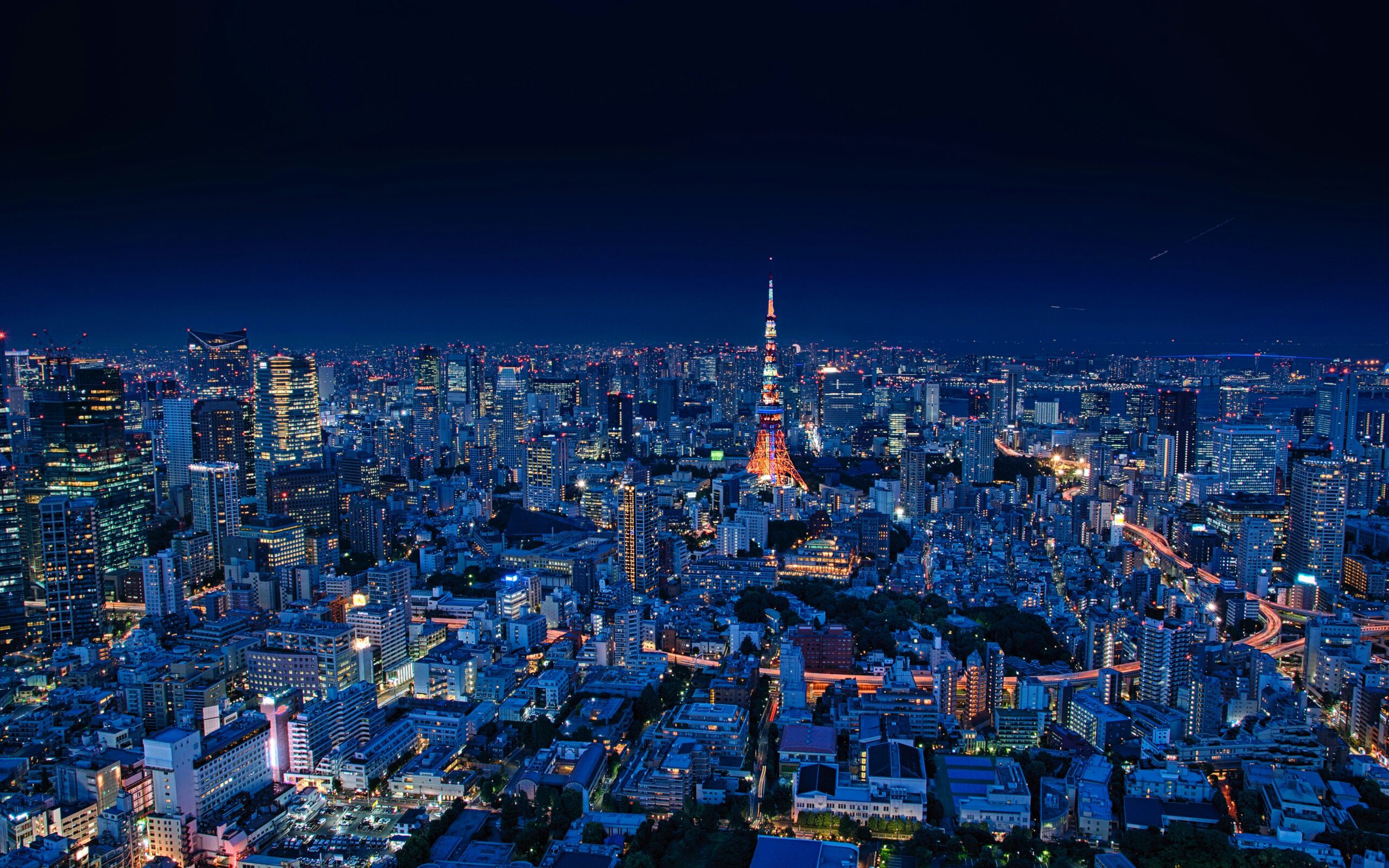Tokyo travel guide hero — Tokyo Tower illuminated at night over the city skyline